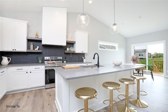 kitchen featuring stainless steel electric range, light hardwood / wood-style flooring, sink, decorative backsplash, and vaulted ceiling