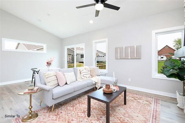 living room featuring lofted ceiling, plenty of natural light, ceiling fan, and light hardwood / wood-style floors