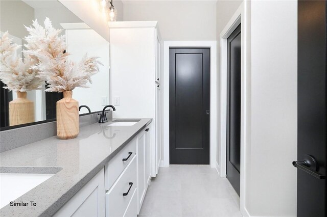 bathroom with tile patterned flooring and vanity