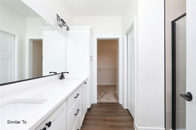 bathroom with vanity, hardwood / wood-style floors, and a shower with shower door