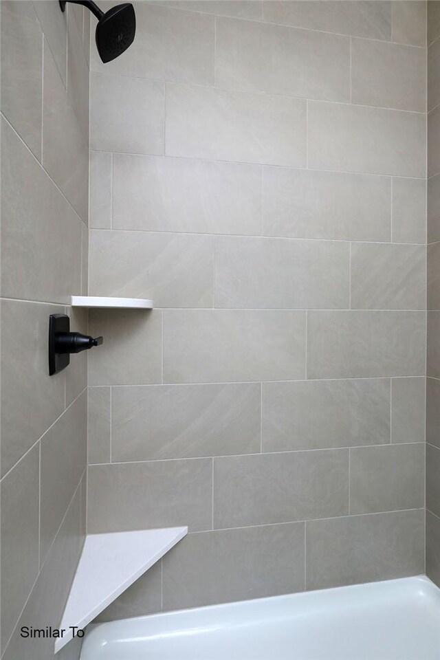 bathroom with a tile shower