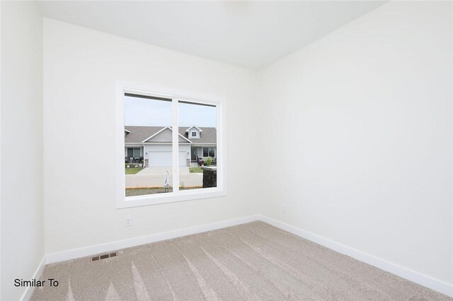 spare room with plenty of natural light and carpet