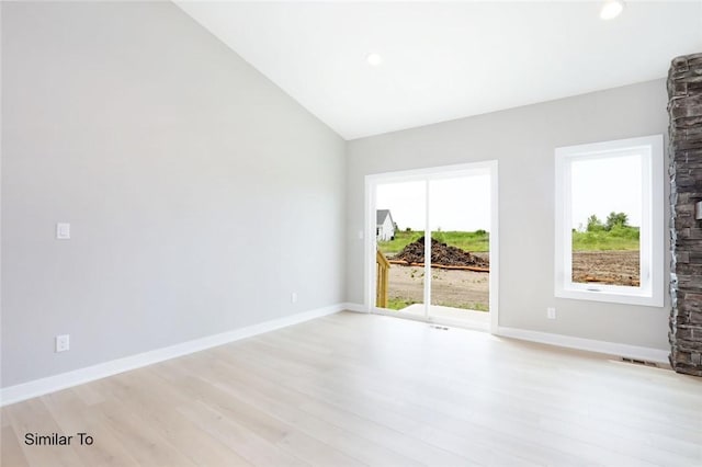 2412 NE 6th St, Grimes, IA 50111 - spare room with light wood-style flooring, visible vents, recessed lighting, lofted ceiling, and baseboards