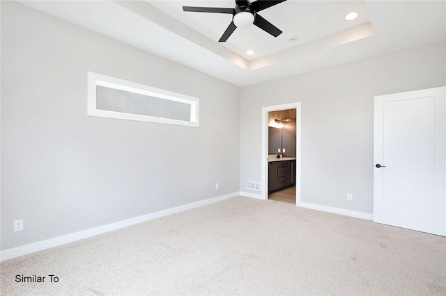 unfurnished bedroom with a raised ceiling, recessed lighting, baseboards, and visible vents