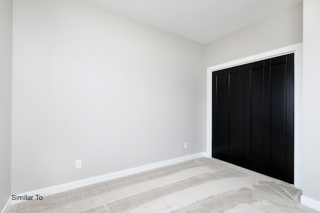 unfurnished bedroom featuring baseboards and carpet flooring