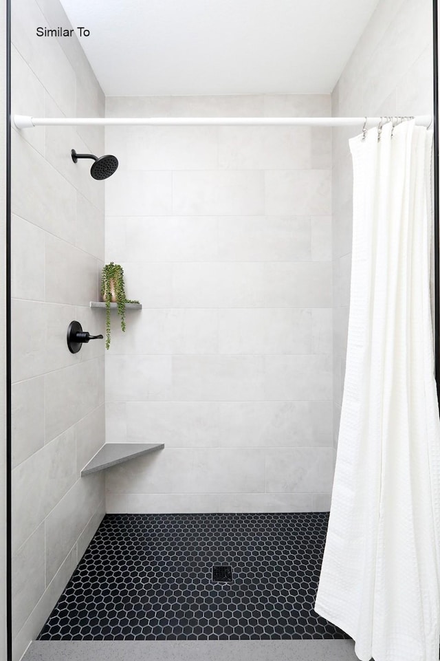 full bath featuring a tile shower