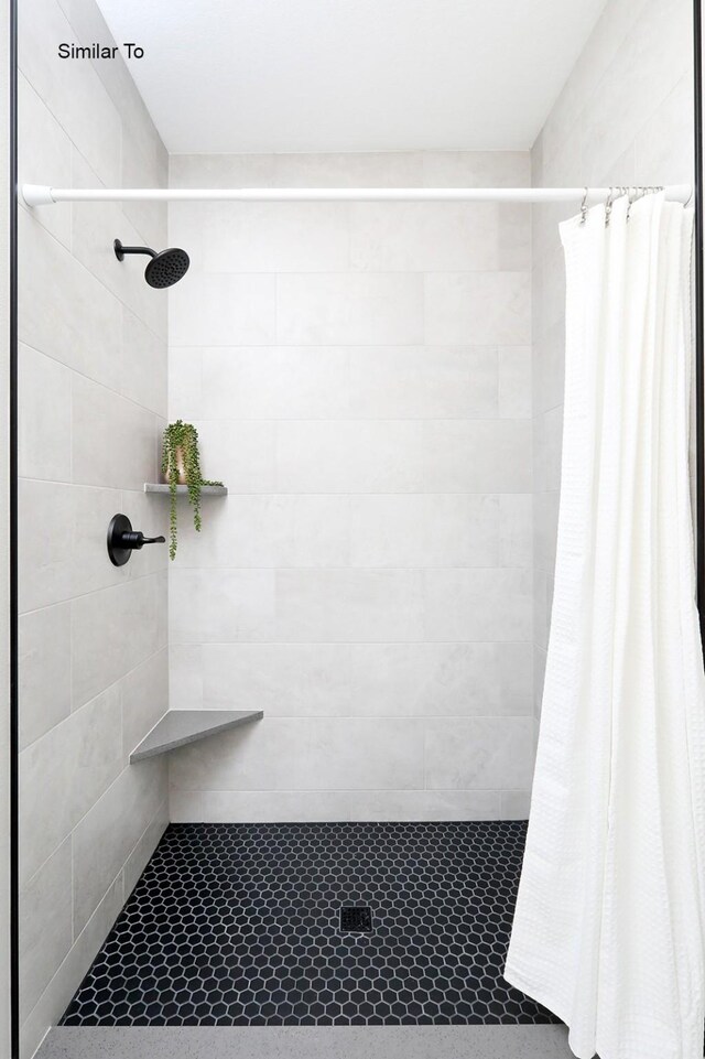 full bathroom with tiled shower