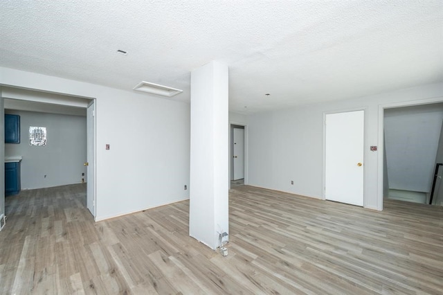 1125 Clinton Ave, Des Moines, IA 50313 - basement featuring light wood-style flooring and a textured ceiling