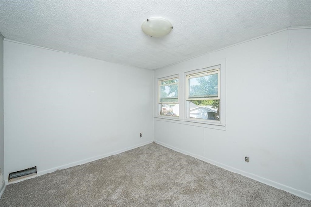 1125 Clinton Ave, Des Moines, IA 50313 - unfurnished room with carpet floors, a textured ceiling, and baseboards