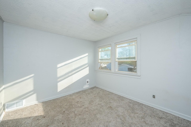 1125 Clinton Ave, Des Moines, IA 50313 - carpeted spare room featuring a textured ceiling and baseboards