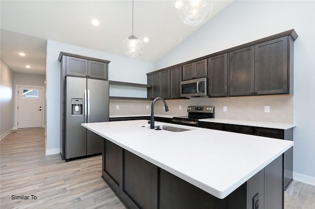 kitchen featuring pendant lighting, a sink, open shelves, stainless steel appliances, and light countertops