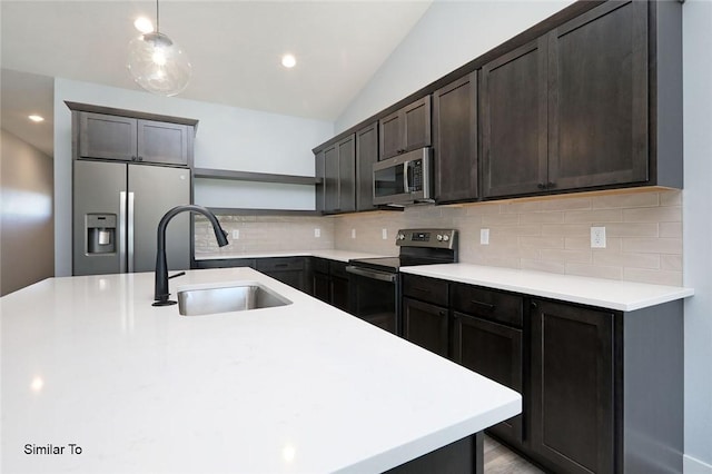 kitchen with tasteful backsplash, a sink, light countertops, appliances with stainless steel finishes, and open shelves