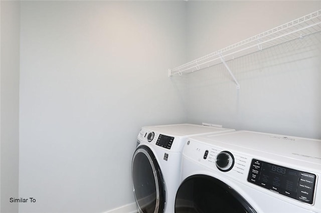 washroom featuring laundry area and washer and clothes dryer