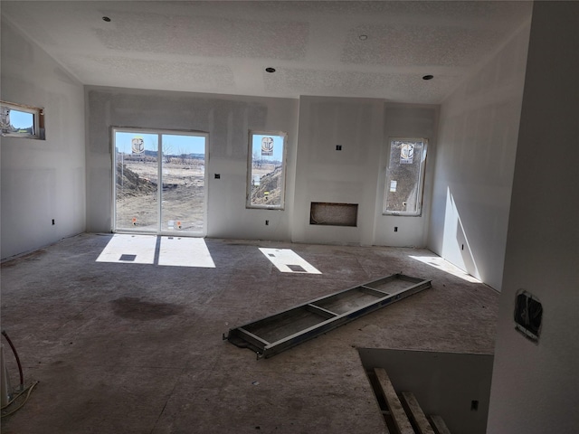 unfurnished living room featuring a fireplace and a textured ceiling