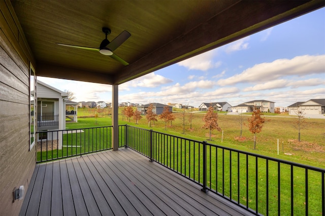 wooden deck with a yard and ceiling fan