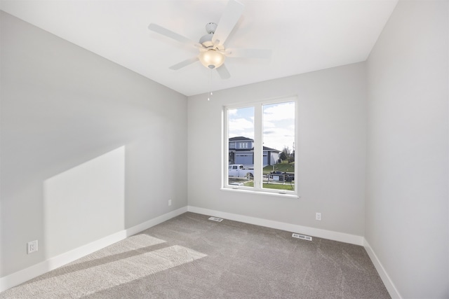 empty room featuring carpet flooring and ceiling fan