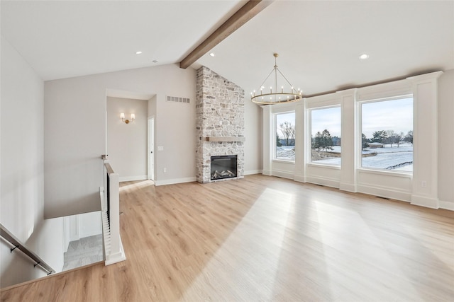 unfurnished living room featuring vaulted ceiling with beams, a fireplace, a chandelier, and light hardwood / wood-style flooring