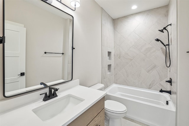 full bathroom featuring vanity, toilet, and tiled shower / bath