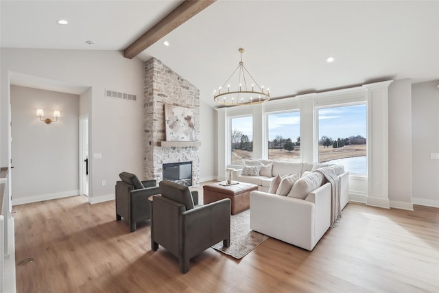 living room with light wood-type flooring, visible vents, and lofted ceiling with beams