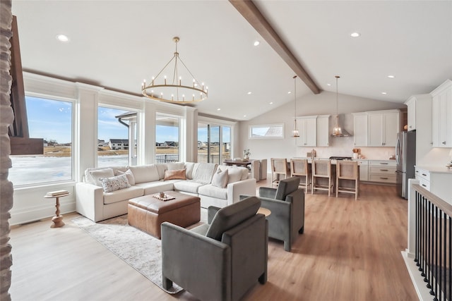 living room with vaulted ceiling with beams, an inviting chandelier, light wood-style flooring, and recessed lighting