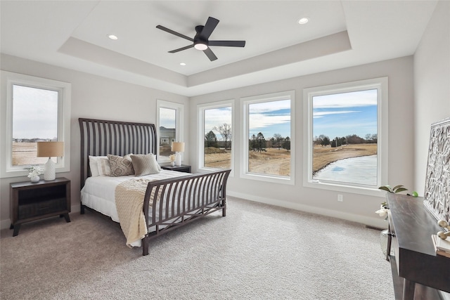 bedroom featuring carpet floors, recessed lighting, a raised ceiling, and baseboards