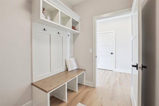 mudroom featuring light wood-style flooring and baseboards