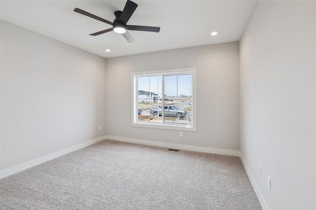 carpeted empty room featuring visible vents, baseboards, a ceiling fan, and recessed lighting