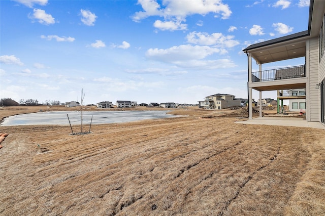 view of yard featuring a water view and a patio