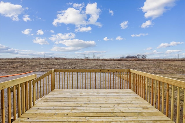 wooden terrace featuring a rural view