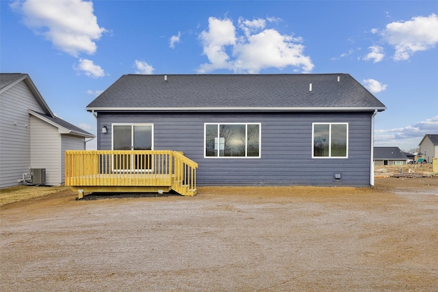 rear view of property with a deck and cooling unit