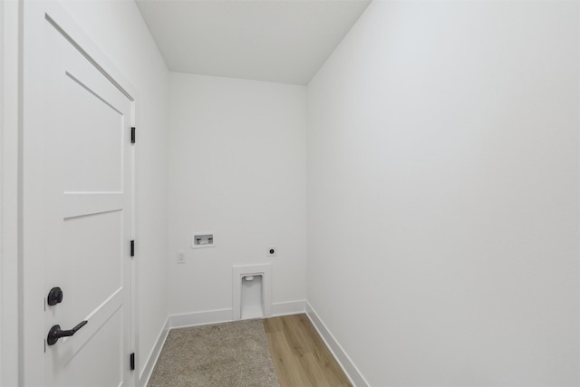 clothes washing area with hookup for an electric dryer, hookup for a washing machine, and light hardwood / wood-style floors