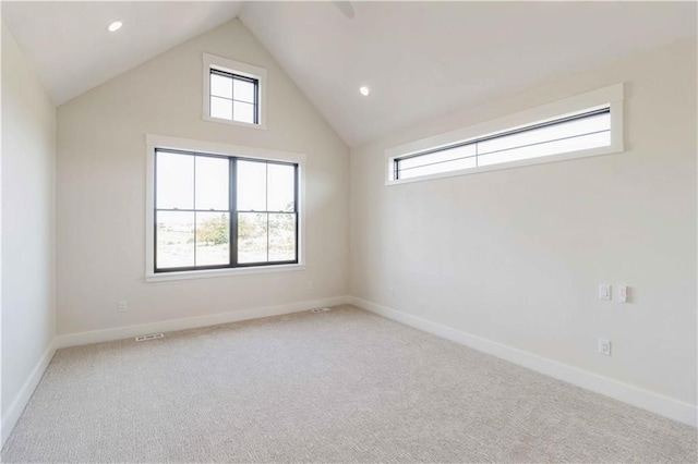 carpeted spare room featuring lofted ceiling, recessed lighting, and baseboards