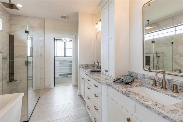 bathroom featuring a shower with door, wood-type flooring, and vanity