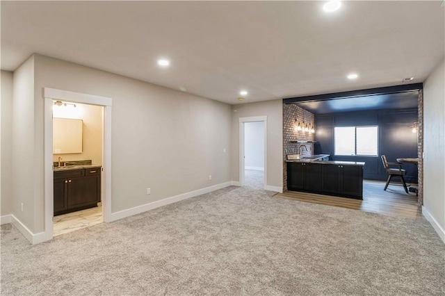 living room featuring light colored carpet and sink