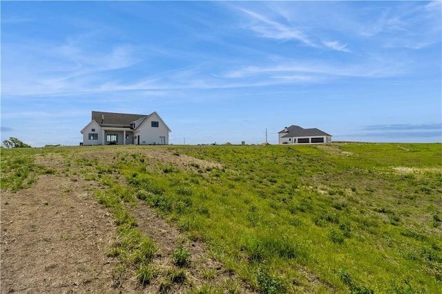 view of yard with a rural view