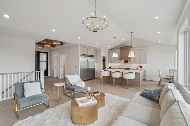 living area with a notable chandelier, recessed lighting, light wood-style flooring, vaulted ceiling, and baseboards