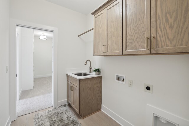 laundry room with hookup for a washing machine, cabinet space, hookup for an electric dryer, a sink, and light carpet