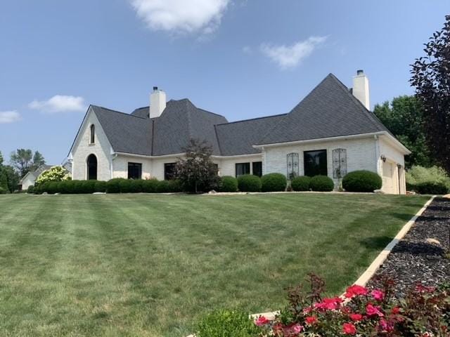 view of front of property with a garage and a front lawn