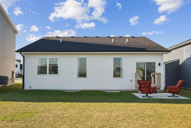 rear view of property with a patio area, a yard, and cooling unit