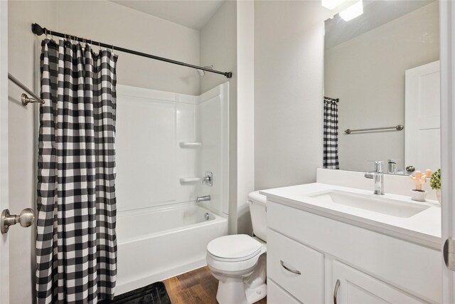 full bathroom with shower / bath combo with shower curtain, toilet, wood-type flooring, and vanity