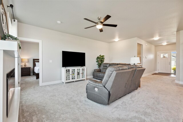 living room featuring ceiling fan and light colored carpet