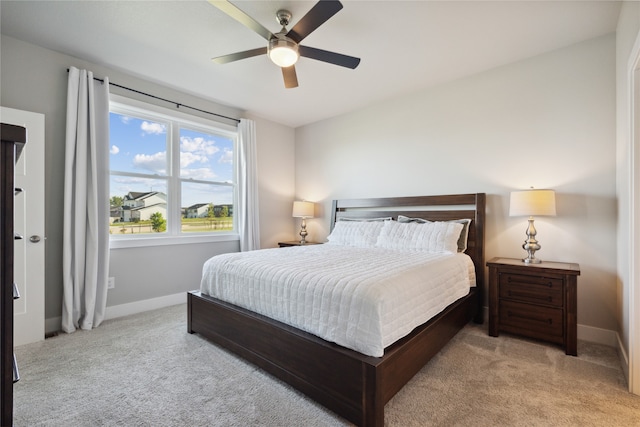 bedroom featuring ceiling fan and light colored carpet