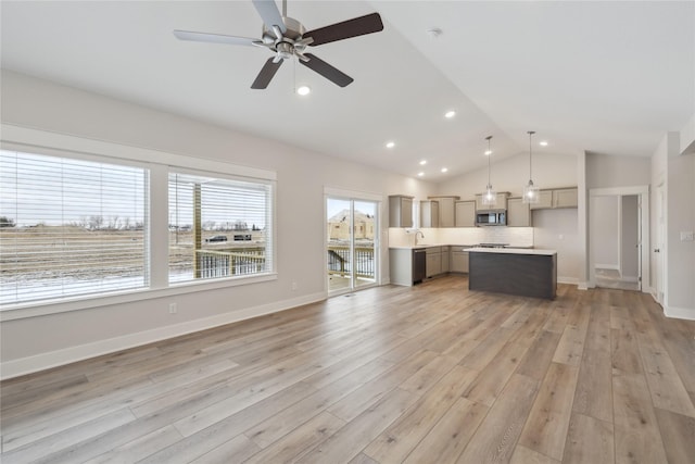 unfurnished living room with light hardwood / wood-style flooring, vaulted ceiling, and ceiling fan