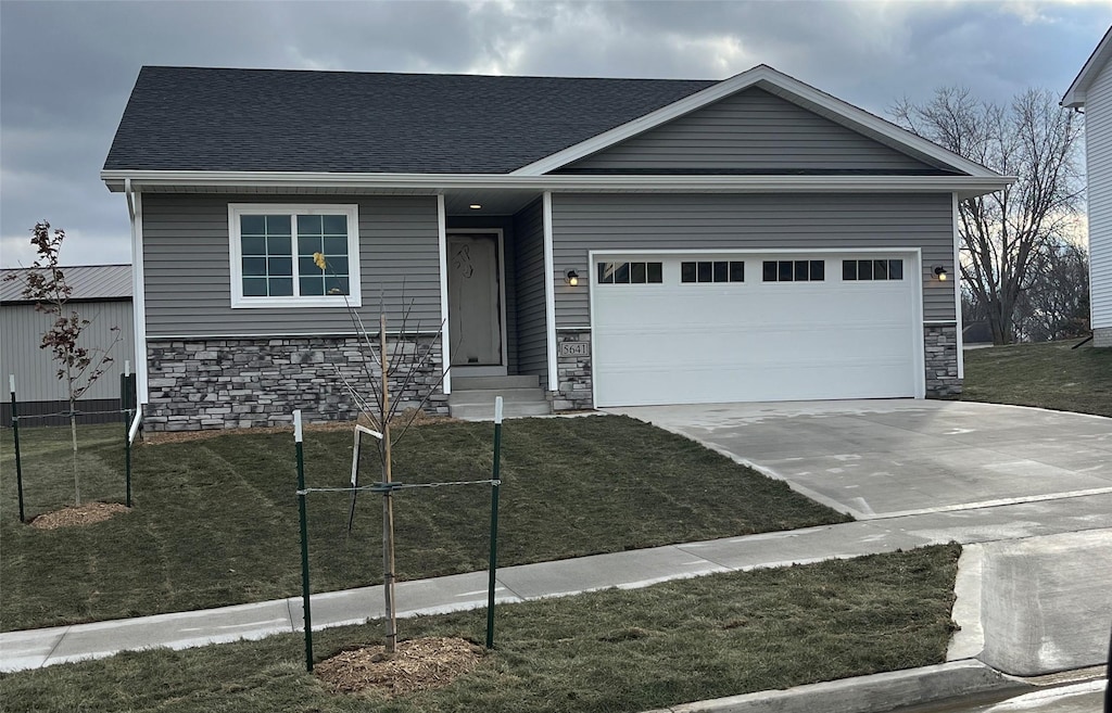 view of front of house with a garage and a front yard