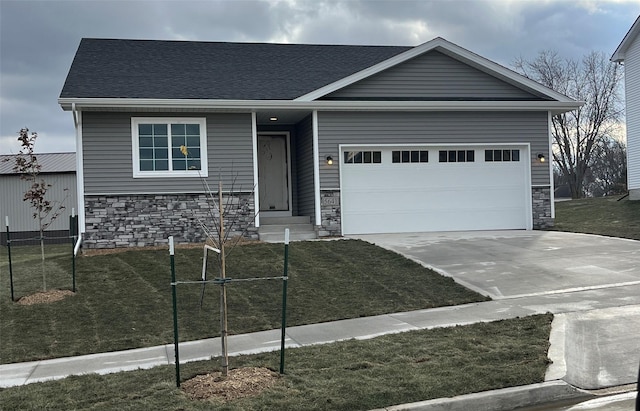 view of front of house with a garage and a front yard