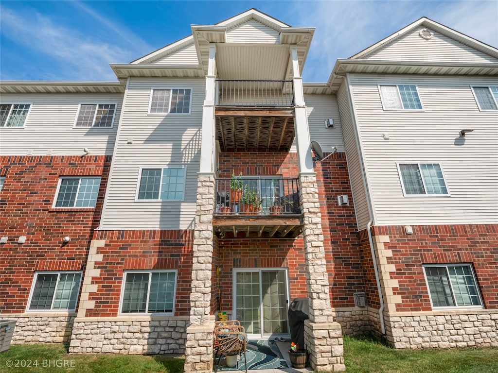 back of property with a balcony