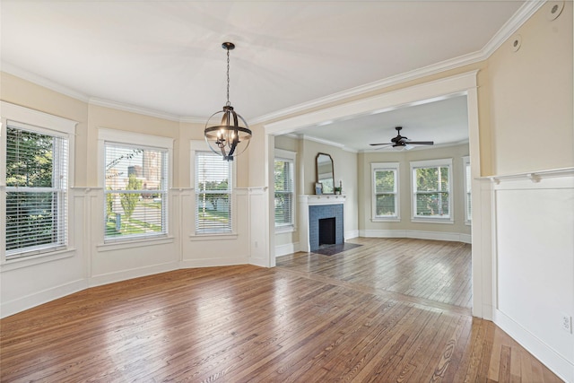 unfurnished living room featuring hardwood / wood-style floors and ornamental molding