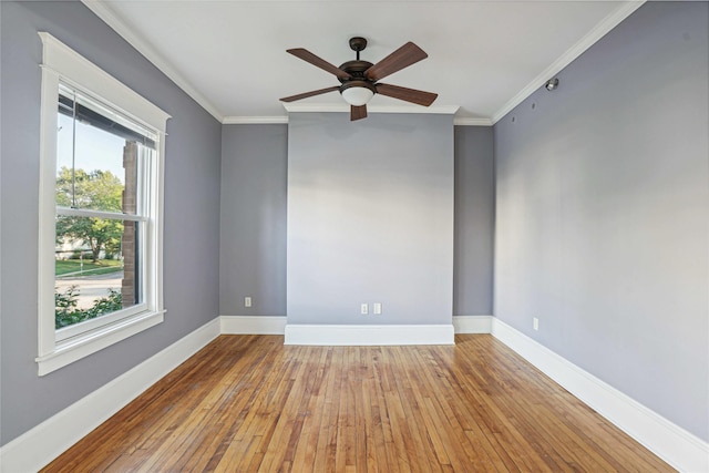 spare room with light hardwood / wood-style floors, plenty of natural light, crown molding, and ceiling fan