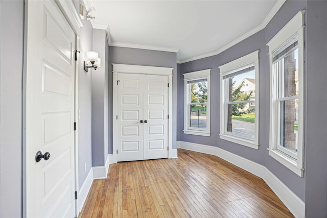 entrance foyer with light hardwood / wood-style floors and ornamental molding