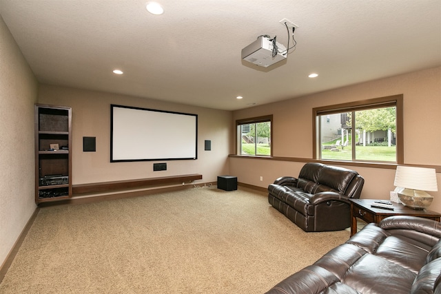 carpeted home theater featuring a textured ceiling